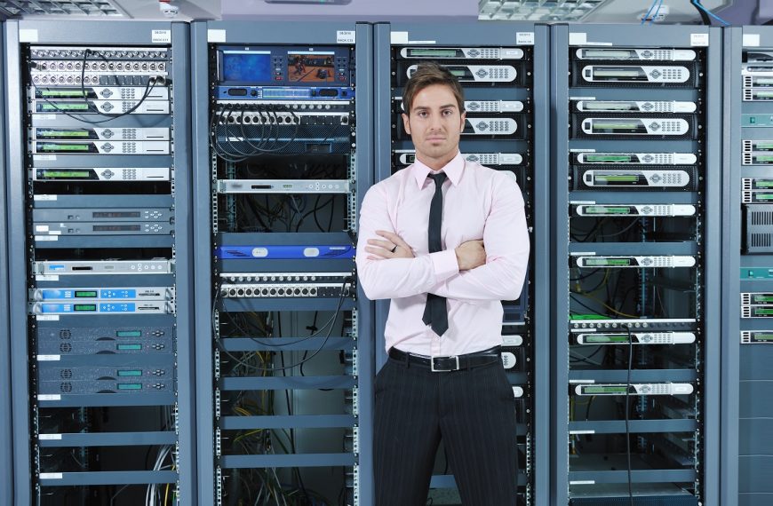 IT guy standing in front of servers